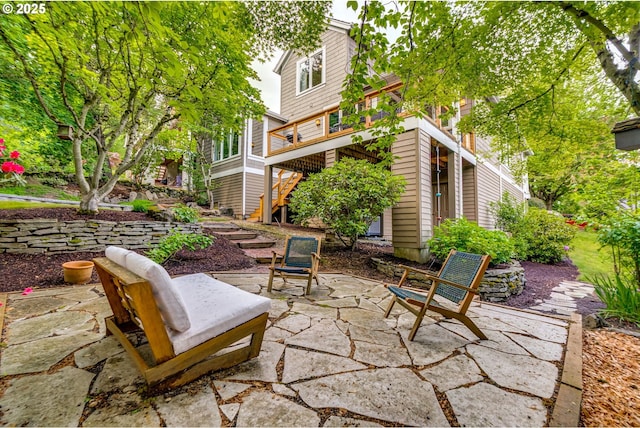view of patio featuring stairs and a wooden deck