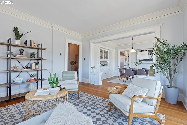 interior space featuring ornamental molding and light hardwood / wood-style floors