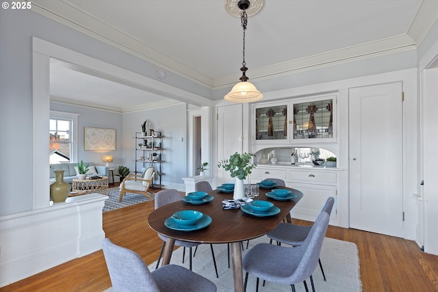 dining space featuring crown molding and hardwood / wood-style floors