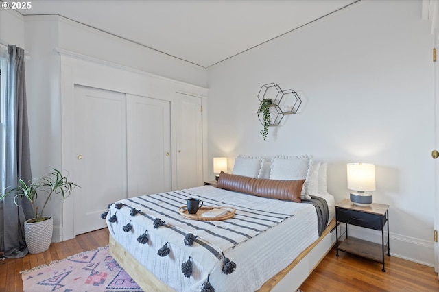 bedroom with hardwood / wood-style floors and a closet