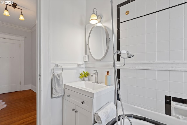 bathroom featuring vanity, hardwood / wood-style floors, and ornamental molding