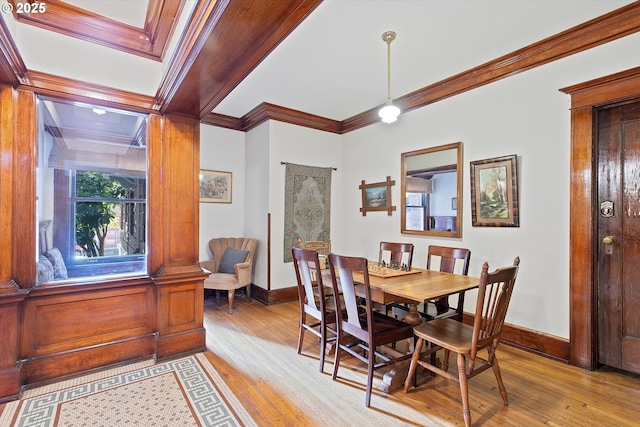 dining room featuring light hardwood / wood-style flooring and ornamental molding