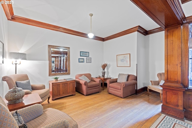 living room with crown molding and light hardwood / wood-style flooring