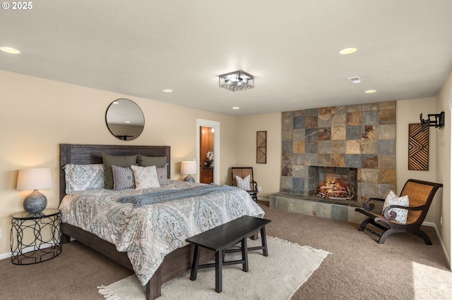bedroom with carpet floors, recessed lighting, baseboards, and a tile fireplace