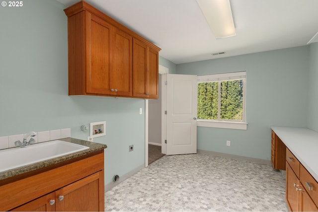 laundry room featuring visible vents, hookup for a washing machine, electric dryer hookup, a sink, and cabinet space