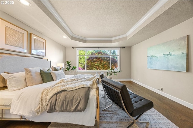 bedroom featuring a textured ceiling, crown molding, baseboards, a tray ceiling, and dark wood-type flooring
