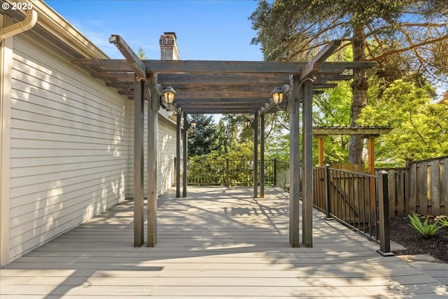 wooden deck featuring fence and a pergola