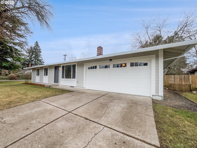 ranch-style home featuring a garage and a front lawn