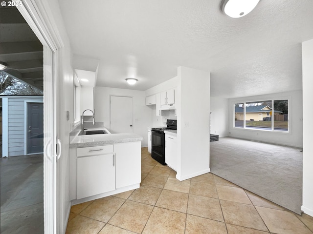 kitchen with sink, white cabinetry, a textured ceiling, black / electric stove, and light colored carpet