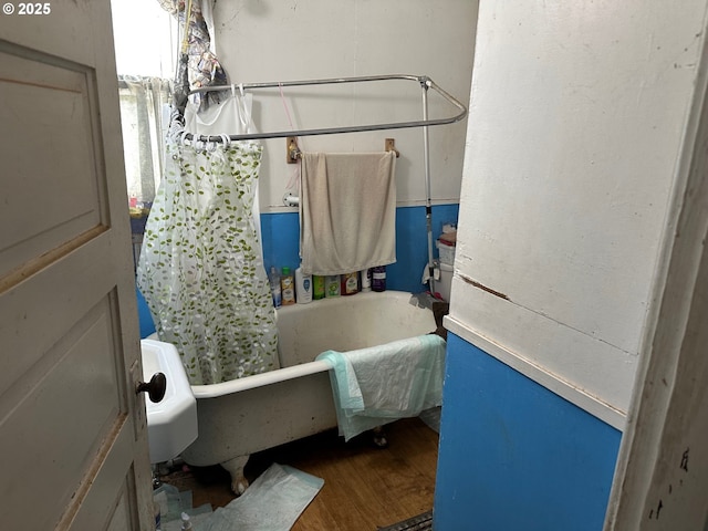 bathroom featuring hardwood / wood-style flooring and shower / bath combination with curtain