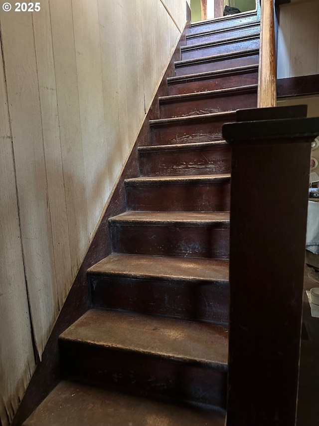 stairway with wood walls