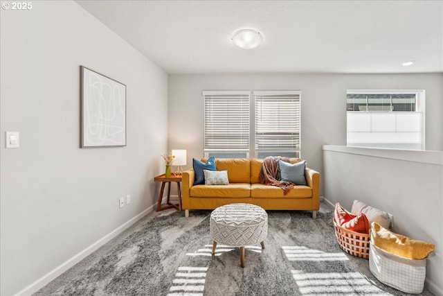 sitting room featuring baseboards and carpet