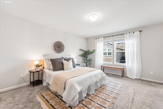 bedroom featuring baseboards and light carpet