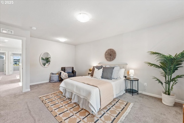carpeted bedroom with baseboards and visible vents