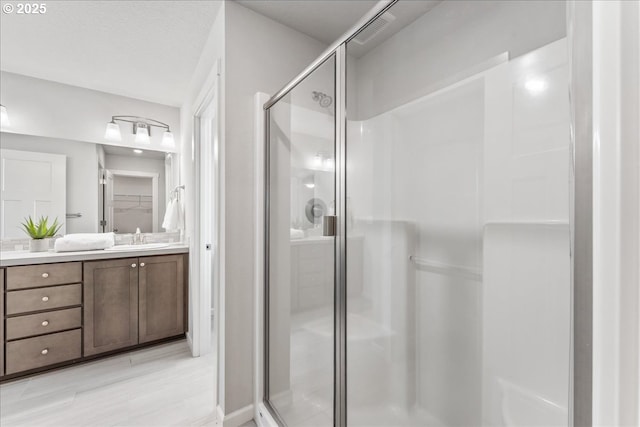 bathroom featuring vanity, visible vents, and a shower stall
