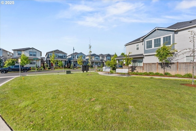 view of yard with a residential view and fence