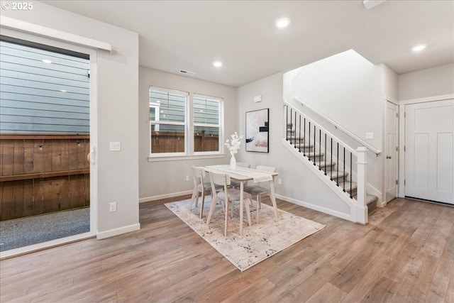 dining room featuring stairs, recessed lighting, baseboards, wood finished floors, and visible vents