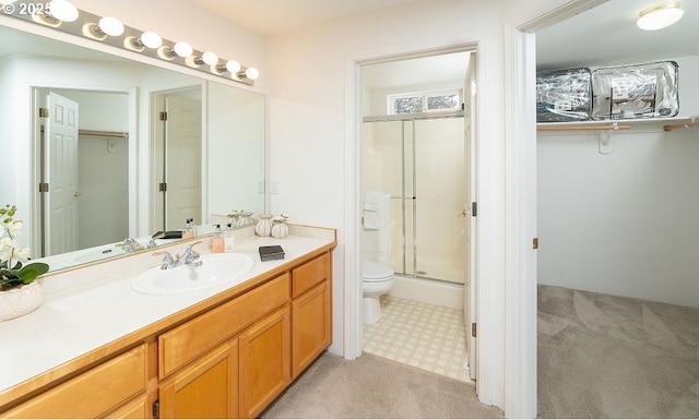 bathroom featuring an enclosed shower, vanity, and toilet