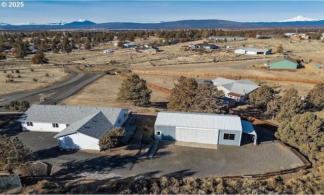 birds eye view of property with a mountain view