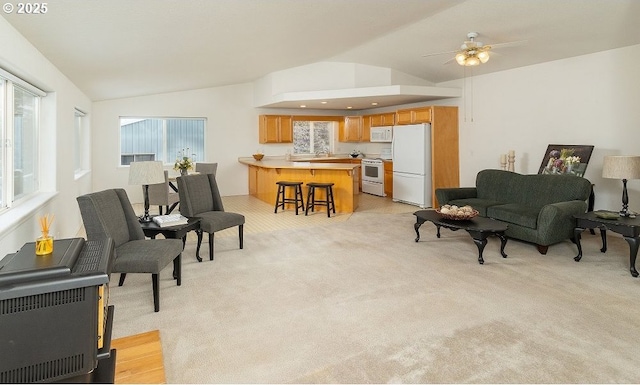 carpeted living room with vaulted ceiling