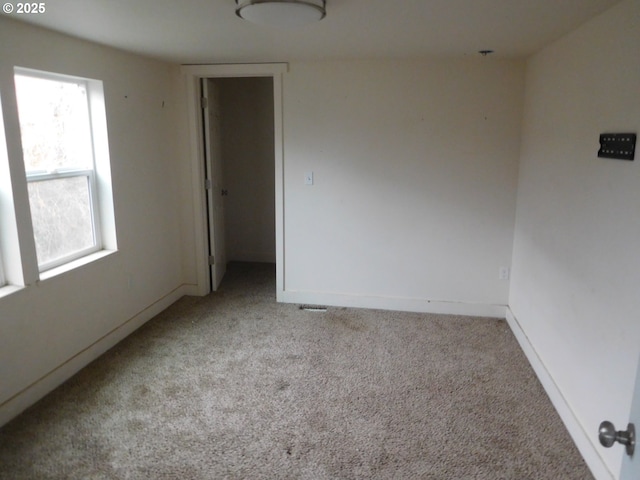 spare room with light carpet