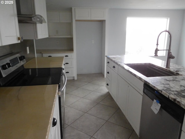 kitchen with stainless steel appliances, sink, and white cabinets