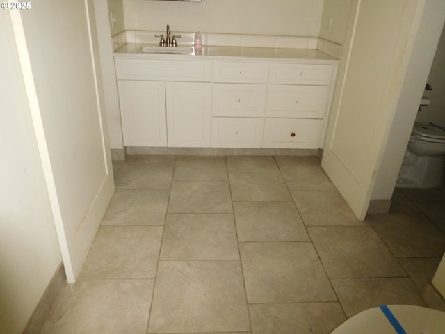 bathroom with tile patterned floors, toilet, and vanity