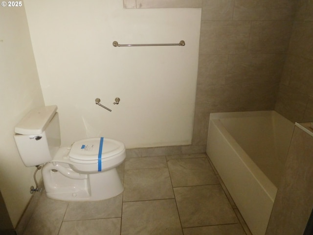 bathroom with toilet, tile patterned flooring, and a bathtub