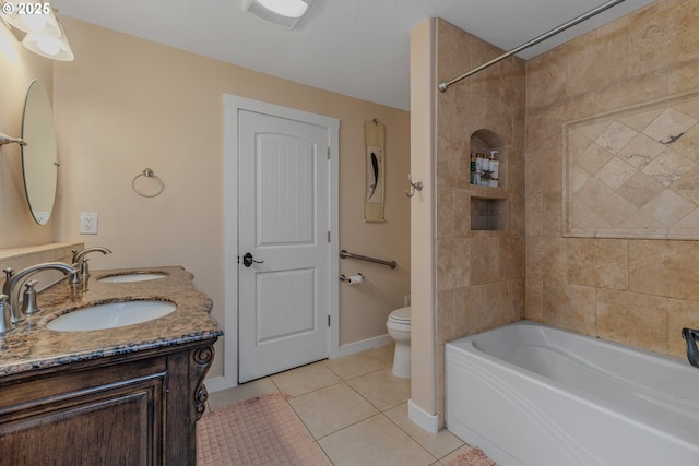 full bathroom featuring vanity, tiled shower / bath combo, tile patterned floors, and toilet