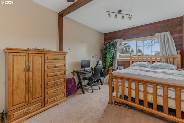 bedroom featuring light carpet and vaulted ceiling with beams