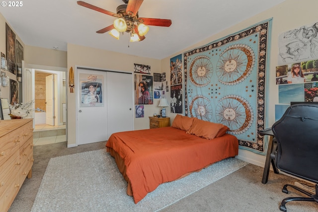 carpeted bedroom featuring ceiling fan and a closet