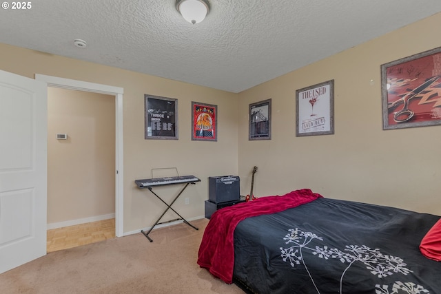 bedroom featuring light carpet and a textured ceiling