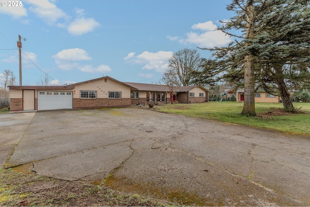 ranch-style house featuring a garage and a front yard