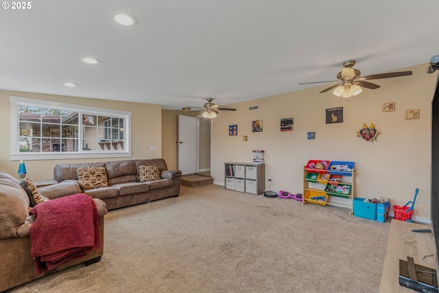 carpeted living room with ceiling fan