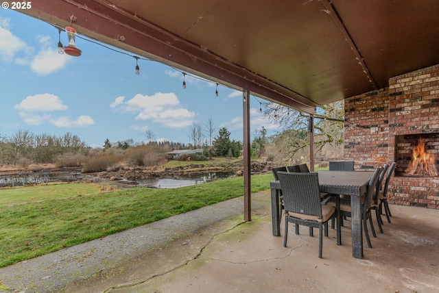 view of patio / terrace with an outdoor brick fireplace