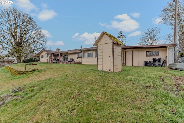 back of property featuring a lawn