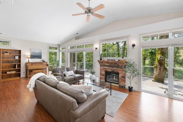 690 N Shepherd Rd, Washougal, WA 98671 - living area with vaulted ceiling, ceiling fan, wood finished floors, a fireplace, and baseboards