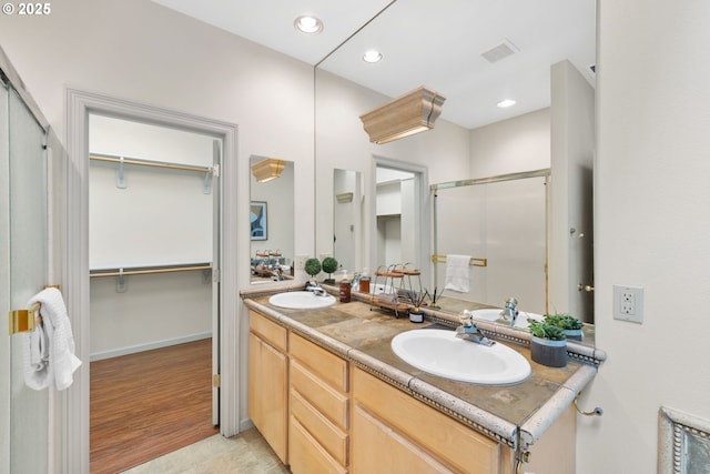 690 N Shepherd Rd, Washougal, WA 98671 - bathroom featuring a shower stall, double vanity, a spacious closet, recessed lighting, and wood finished floors
