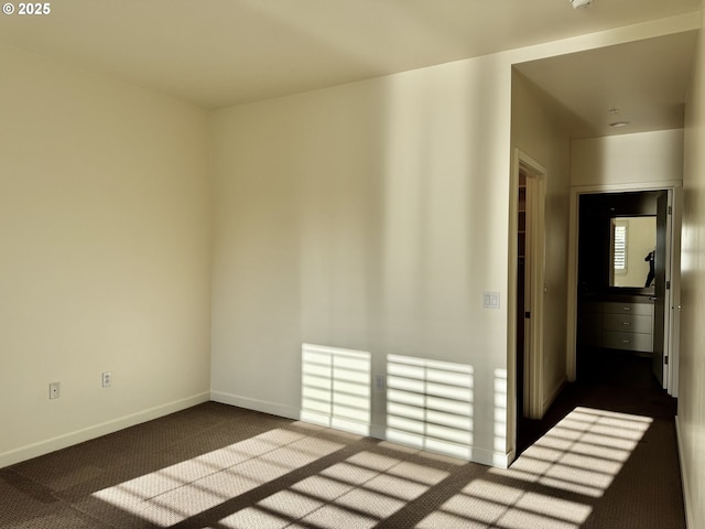 821 NW 11th Ave Unit 315, Portland, OR 97209 - spare room featuring dark colored carpet and baseboards