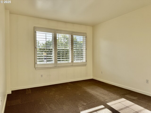 821 NW 11th Ave Unit 315, Portland, OR 97209 - unfurnished room featuring dark colored carpet and baseboards