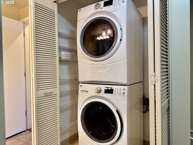 821 NW 11th Ave Unit 315, Portland, OR 97209 - laundry area with stacked washing machine and dryer and light tile patterned flooring