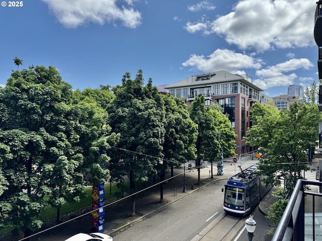 821 NW 11th Ave Unit 315, Portland, OR 97209 - view of asphalt road with traffic signs, sidewalks, and curbs