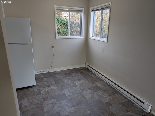 923 S Fir St, Salem, OR 97302 - unfurnished room with a baseboard heating unit, baseboards, and dark stone finish flooring