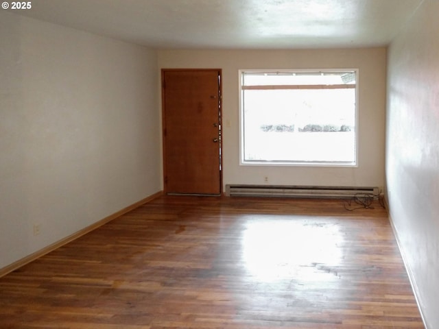 923 S Fir St, Salem, OR 97302 - spare room with wood finished floors, a baseboard heating unit, and baseboards