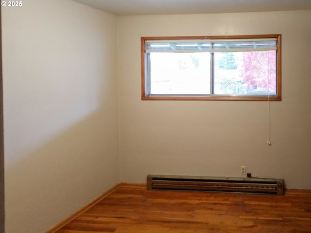923 S Fir St, Salem, OR 97302 - unfurnished room with wood finished floors and a baseboard radiator