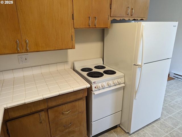 923 S Fir St, Salem, OR 97302 - kitchen with white appliances, tile counters, light tile patterned floors, and a baseboard heating unit