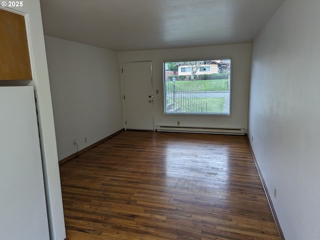 923 S Fir St, Salem, OR 97302 - empty room featuring baseboard heating, wood finished floors, and baseboards