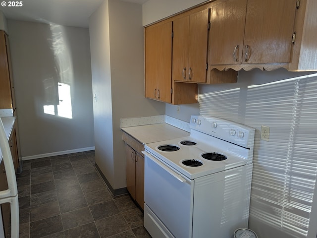 923 S Fir St, Salem, OR 97302 - kitchen featuring electric range, baseboards, light countertops, and stone finish flooring