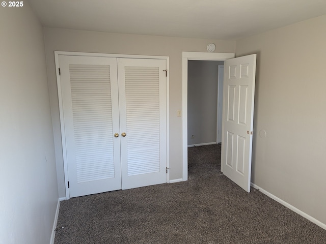 923 S Fir St, Salem, OR 97302 - unfurnished bedroom with dark colored carpet, baseboards, and a closet