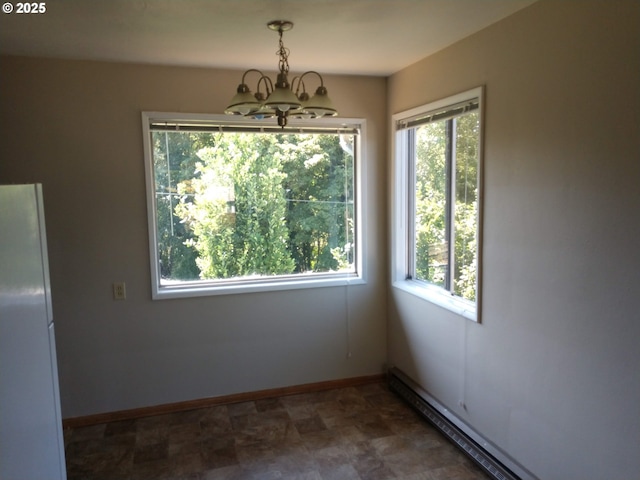 923 S Fir St, Salem, OR 97302 - unfurnished dining area featuring a chandelier, healthy amount of natural light, baseboards, and a baseboard heating unit